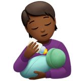 🧑🏾‍🍼 Person Feeding Baby: Medium-Dark Skin Tone, Emoji by Apple